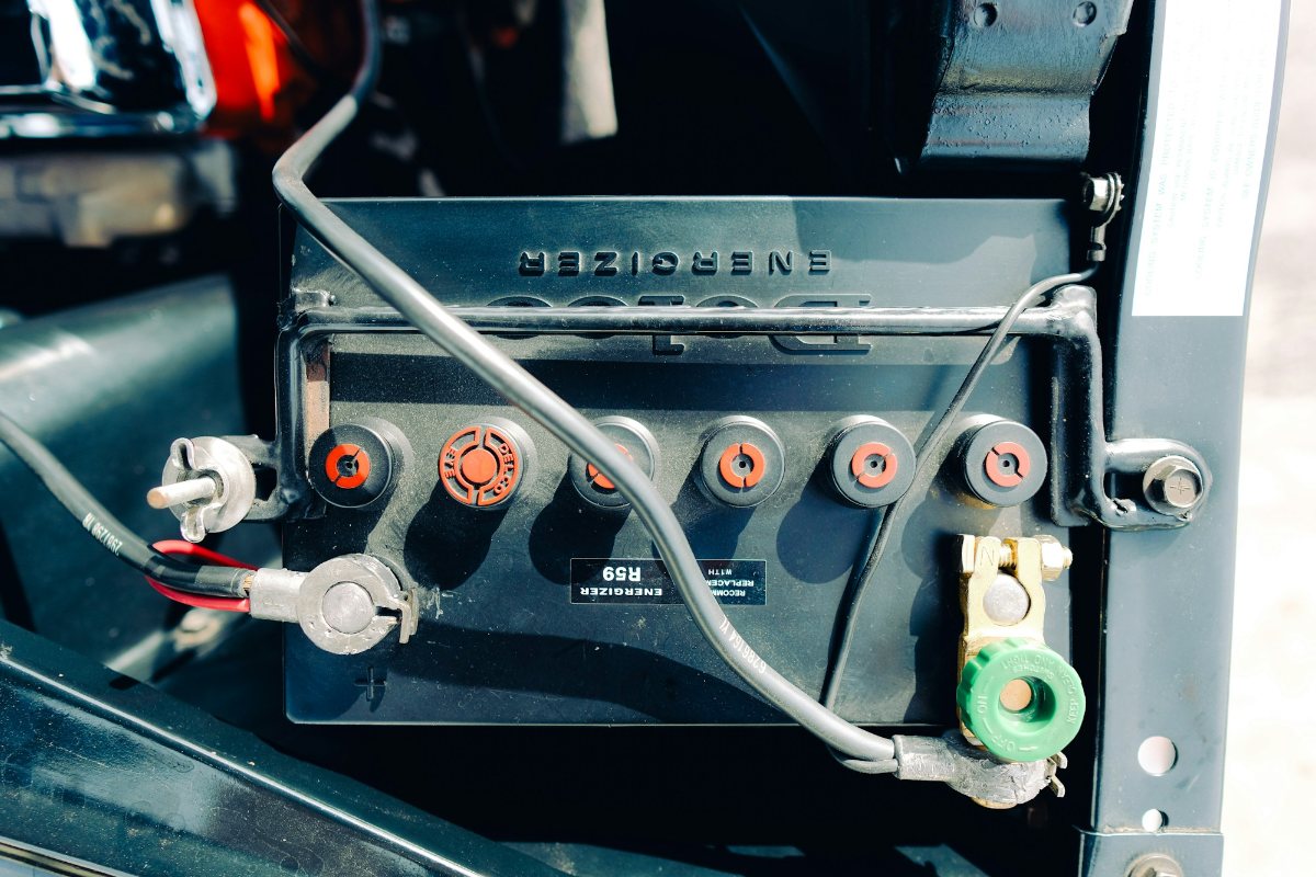 Close-up of a battery with cables connected to its terminals